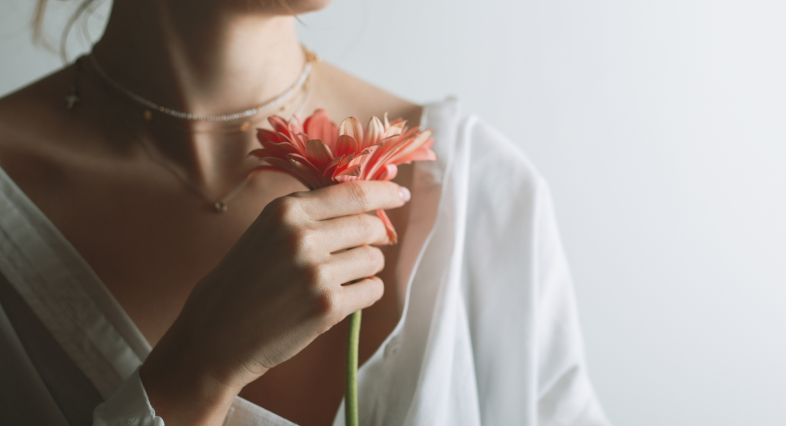 photo -illustrating vaginal health: a woman holding a flower with a white background