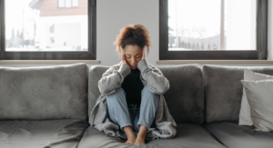 photo - woman with burnout sitting on sofa