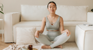 photo- woman meditating in front of sofa - how to meditate